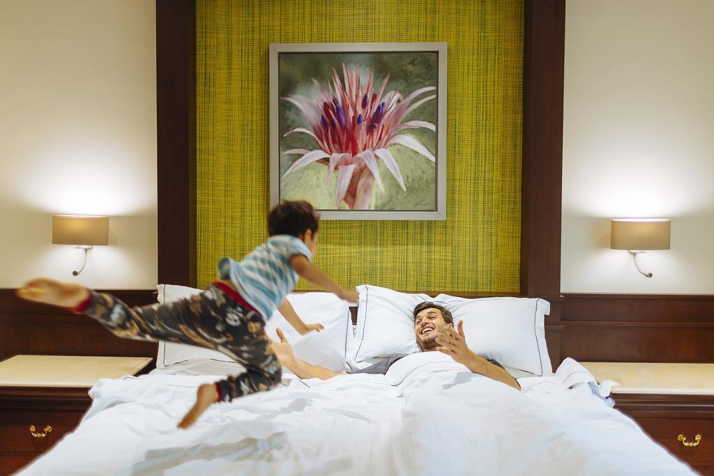 Occidental At Xcaret Destination Hotel Playa del Carmen Ngoại thất bức ảnh A child jumps on a bed.